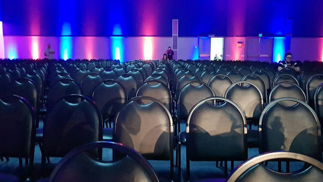 Conference stage with screen and seating before a forum session