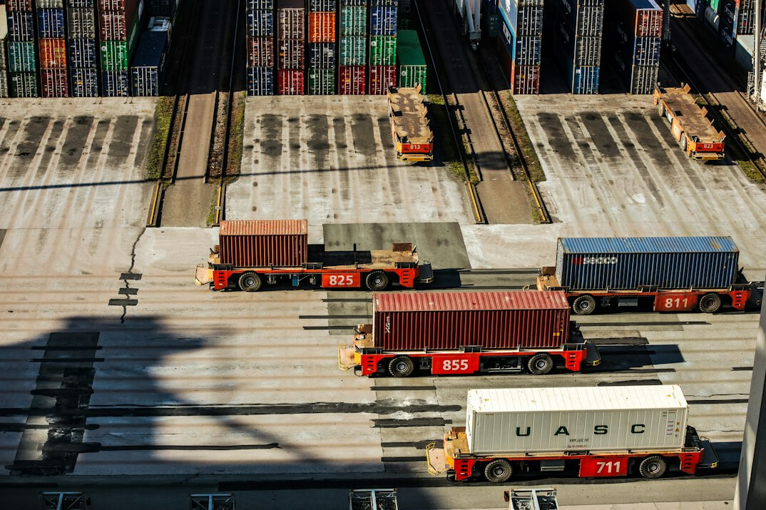Shipping containers and logistics trucks at a distribution hub